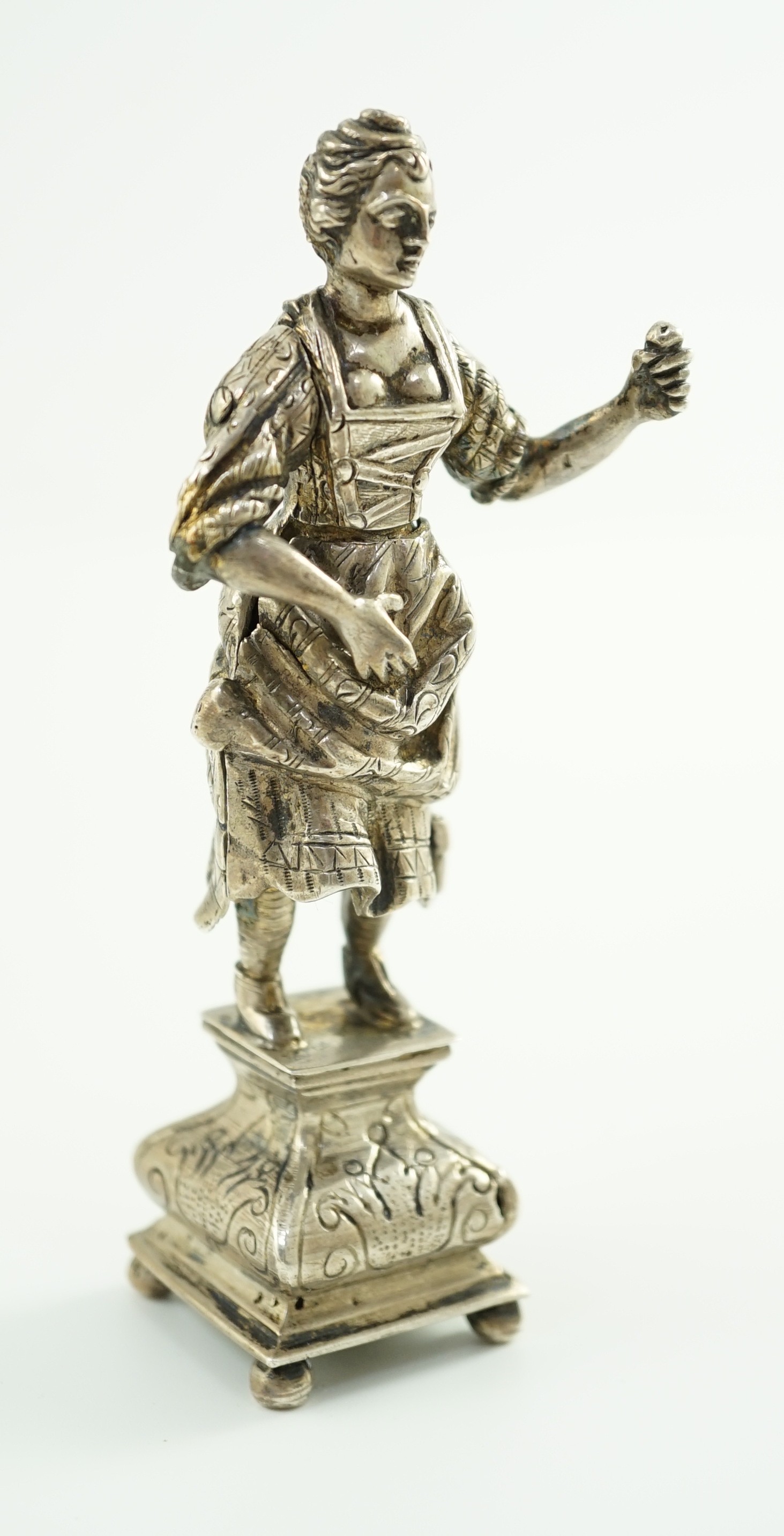 A late 19th century Dutch silver erotic miniature figure of a lady, on a square base with ball feet